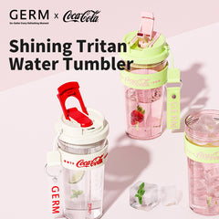 Three GERM x Coca-Cola water tumblers on a light pink background