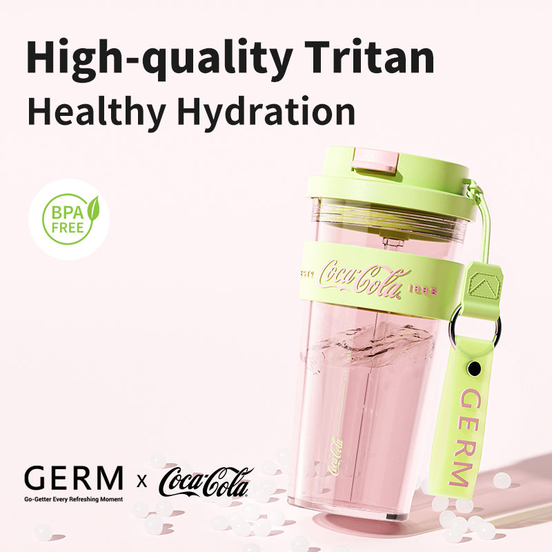 Coca-Cola branded water bottle with green lid and strap on a white background, featuring 'High-quality Tritan Healthy Hydration' text.
