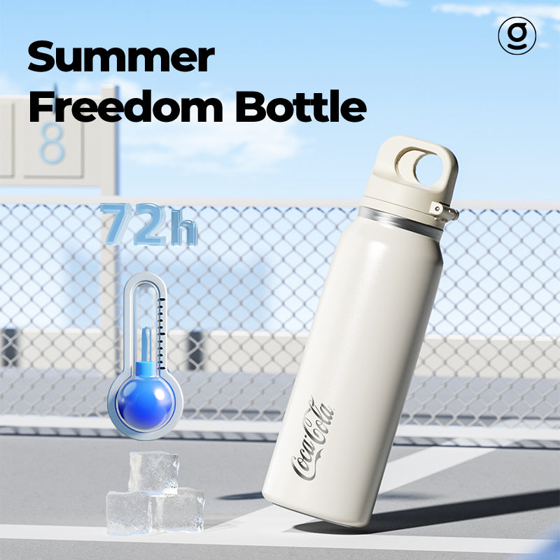 Coca-Cola water bottle with a thermometer on a table outdoors
