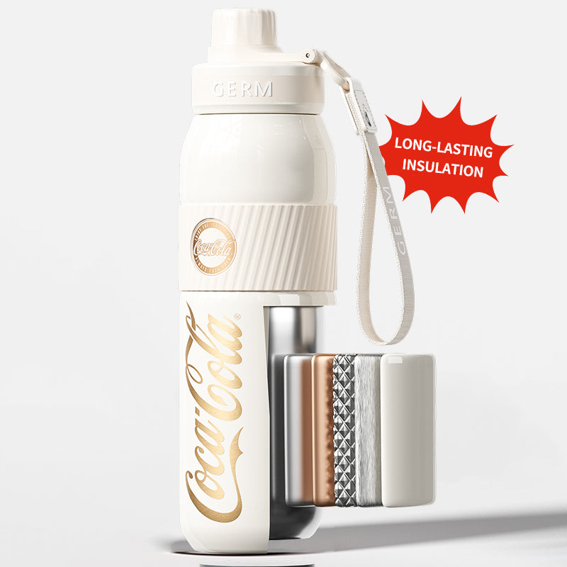 White Coca-Cola insulated bottle with gold lettering on a light gray background