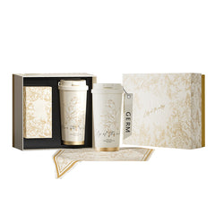 Two white ceramic tumblers with gold text in a decorative box on a white background