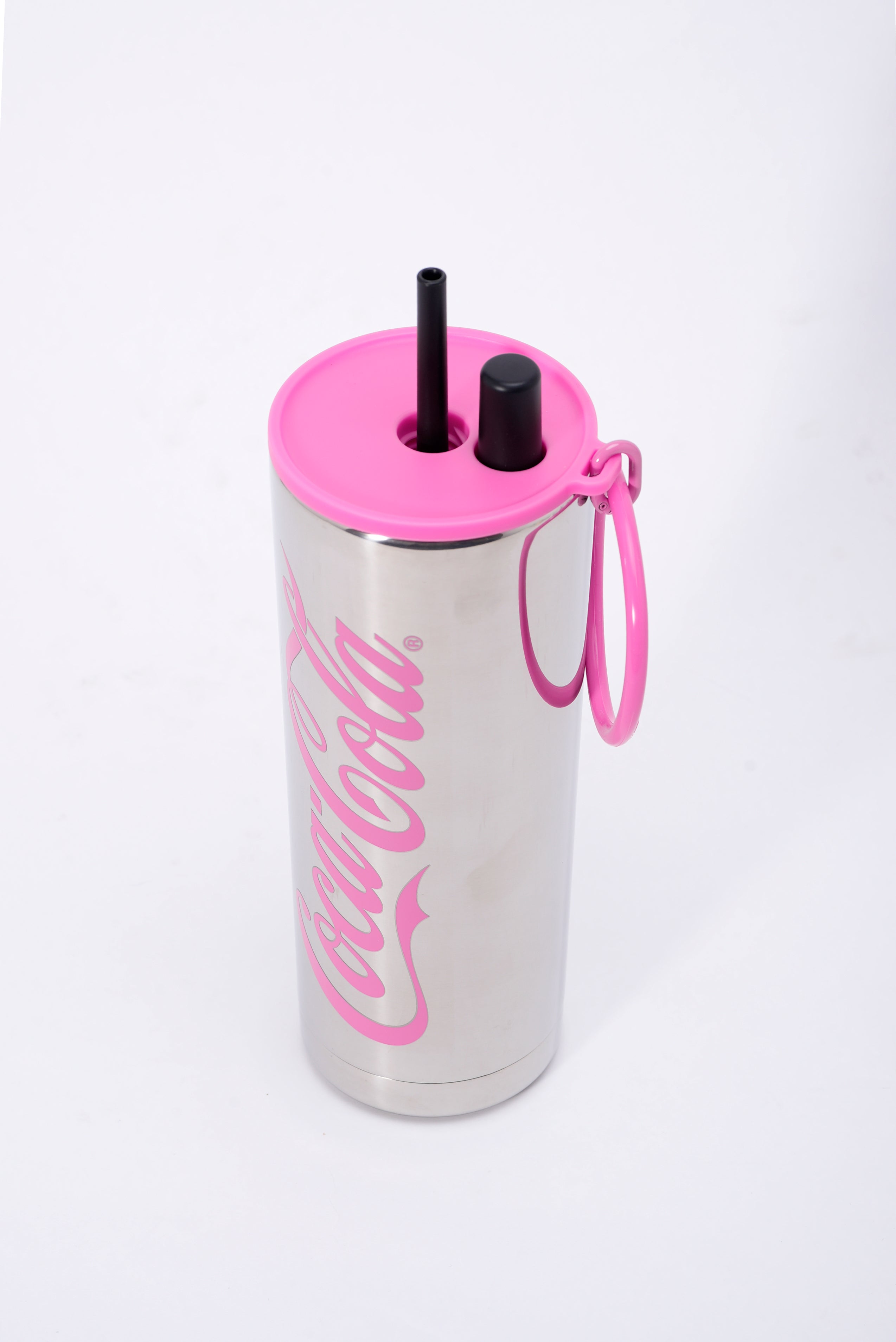 Stainless steel tumbler with pink lid and straw on a white background